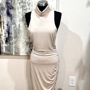 Tan midi mock neck dress with side ruching and exposed zipper at neck